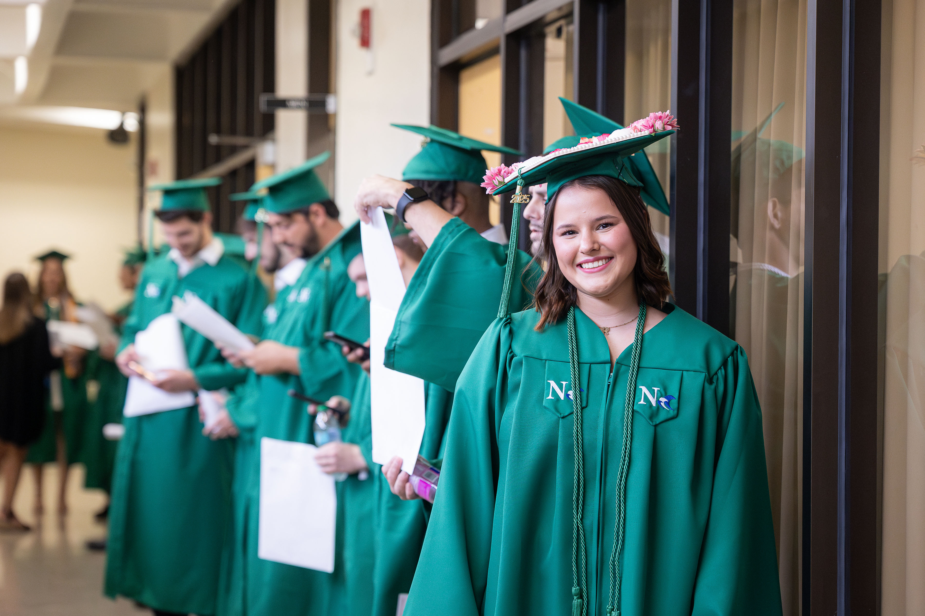 Graduates celebrating in caps and gowns.