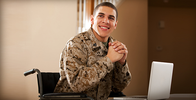 Young veteran smiling in a wheelchair